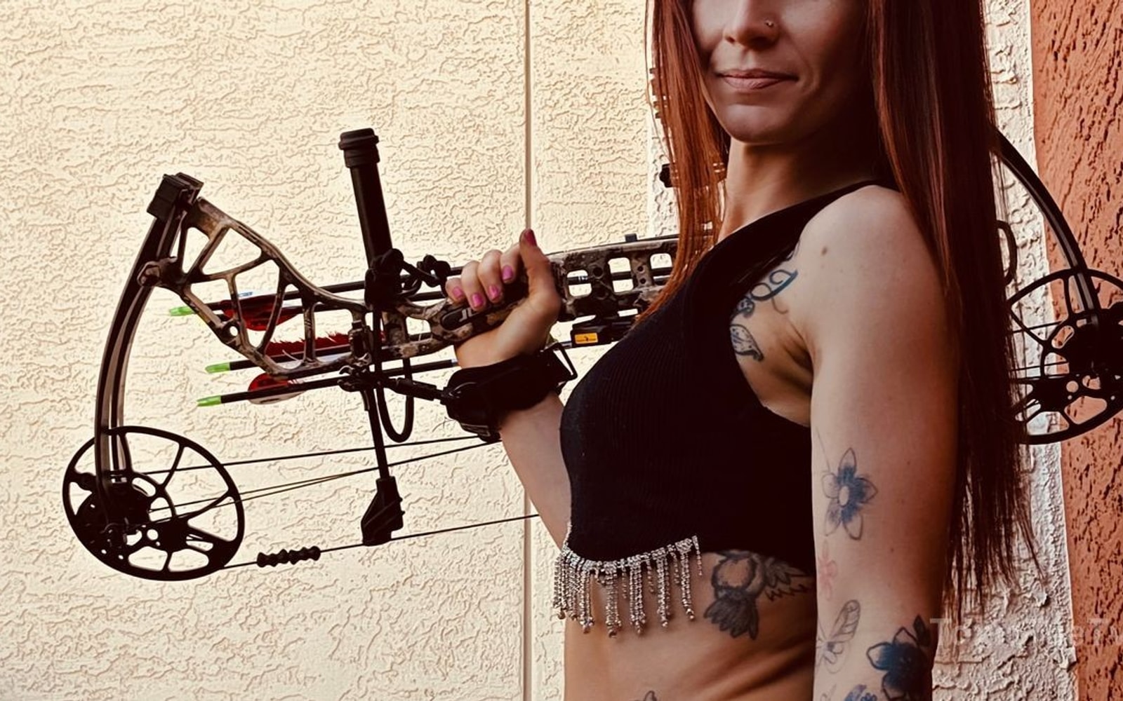 Tee at the range with her compound bow